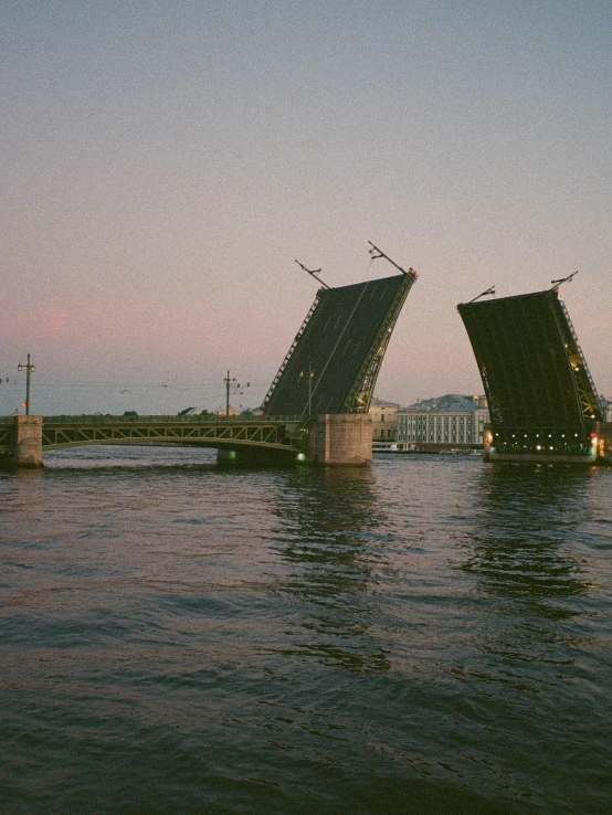 the two large gates in a bridge are partially covered by water