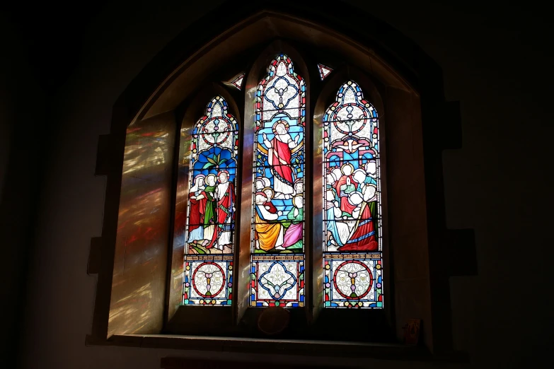 a small colorful stained glass window in a church