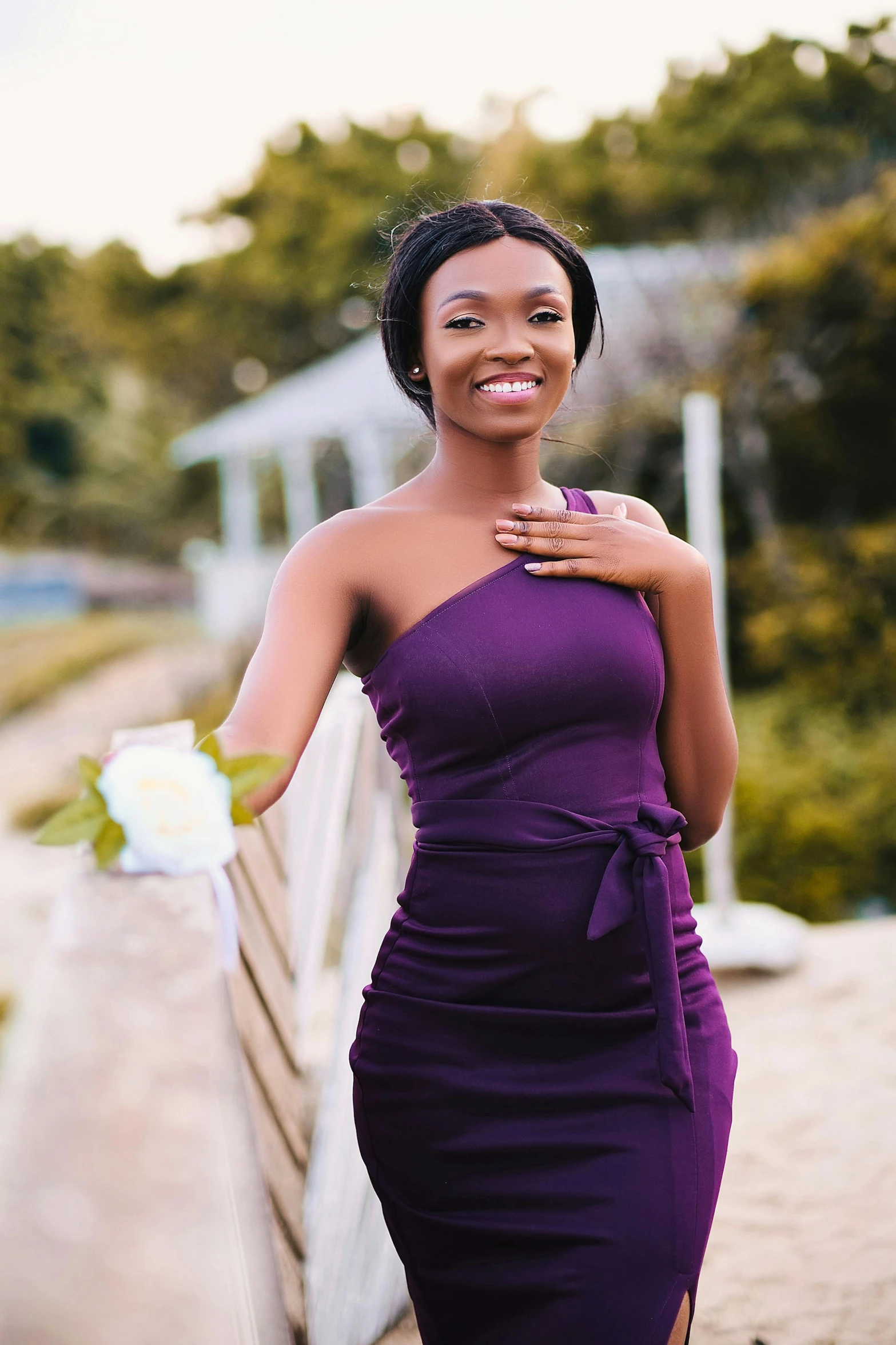 a young woman wearing a purple dress is smiling