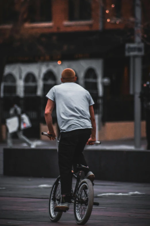 a man riding on a skateboard down the sidewalk