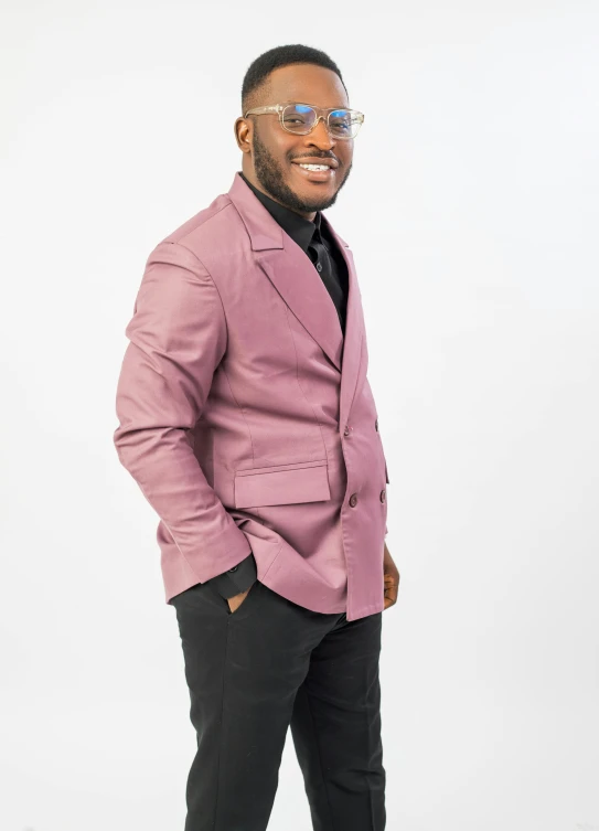 a man wearing a pink suit and smiling at the camera