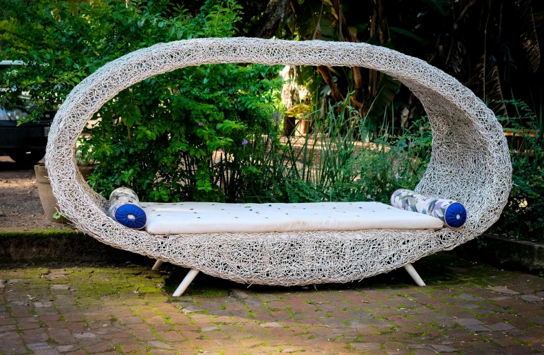 an outdoor bed is placed in the middle of a courtyard