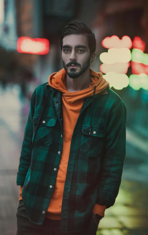 a man is standing in an open city street at night