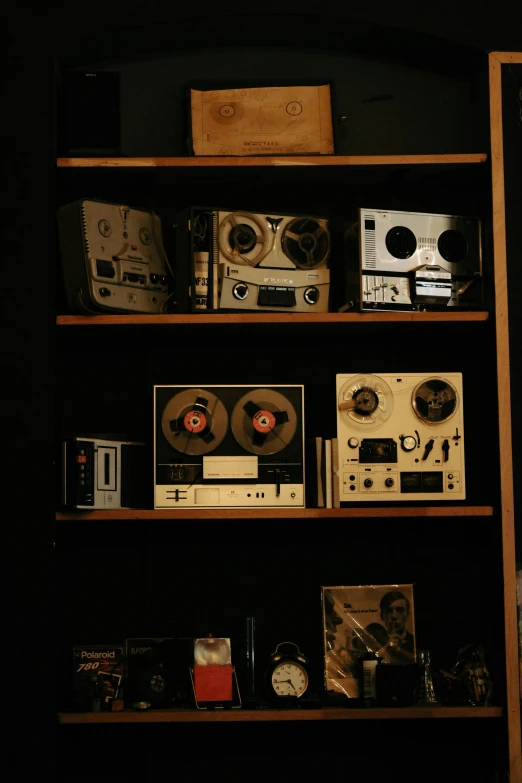 a collection of sound equipment sit in a shelf