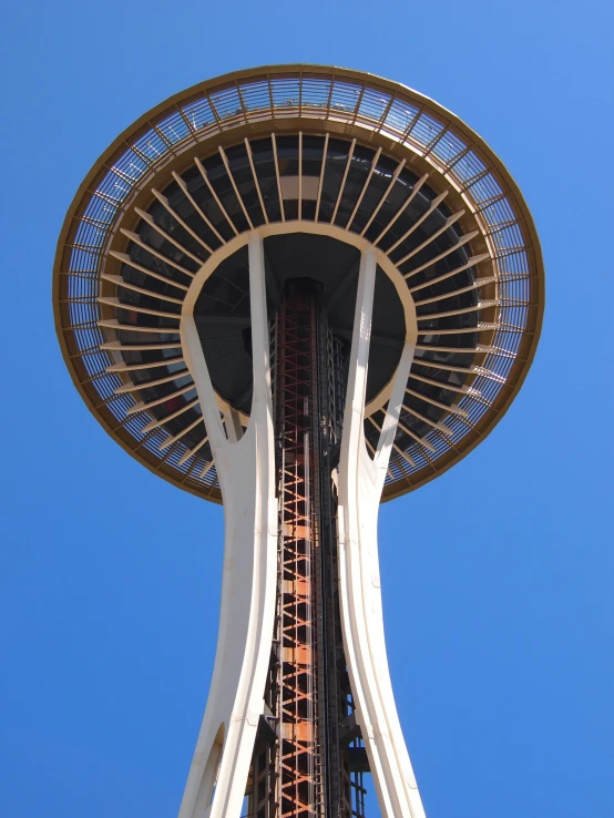 the top view of the space needle, looking up into the blue sky