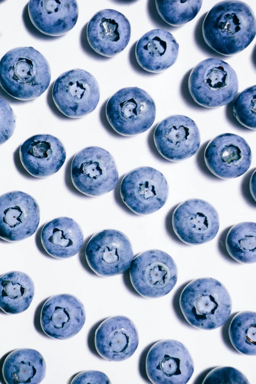 an assortment of blueberries on white background