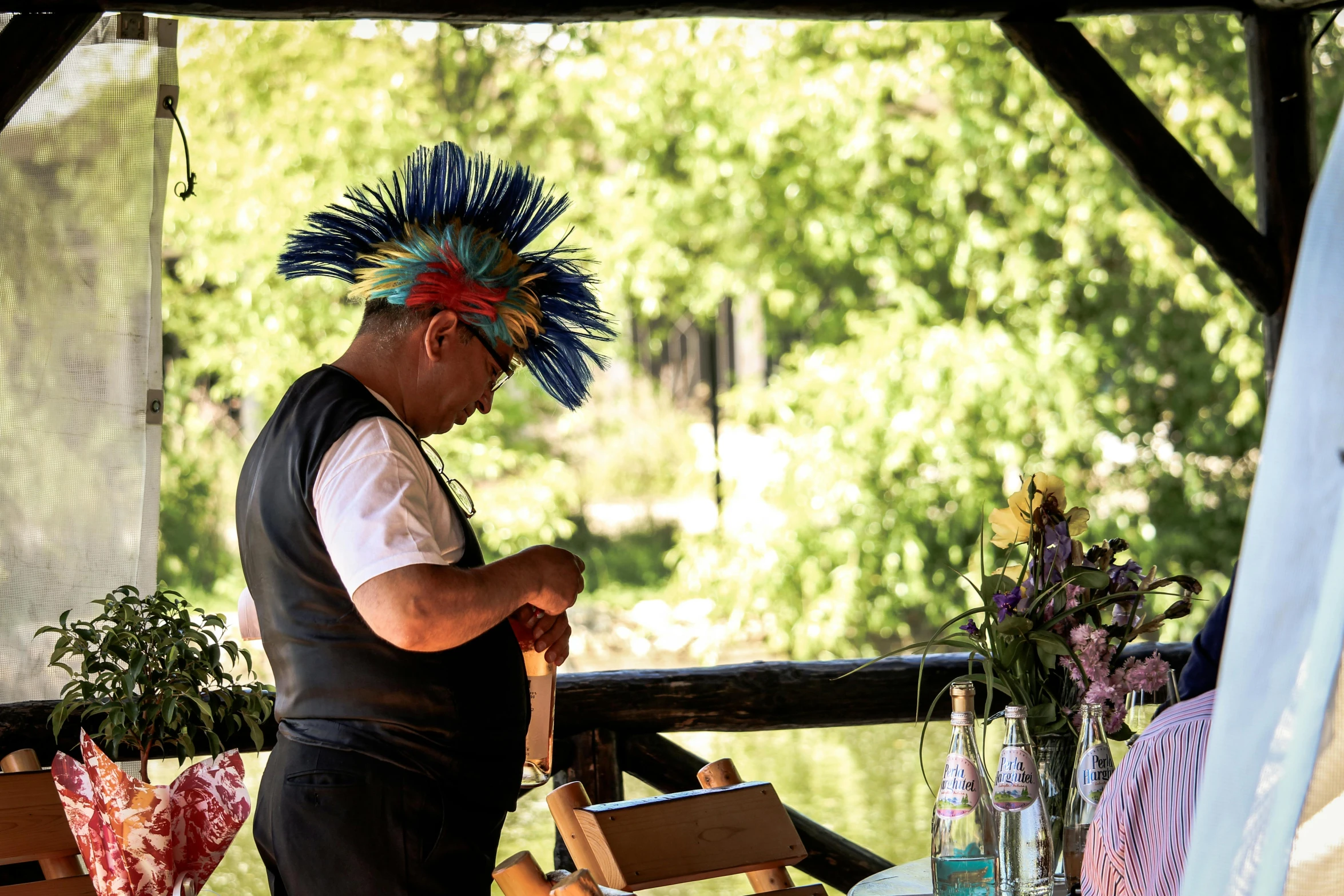 a man dressed in indian head dress preparing soing