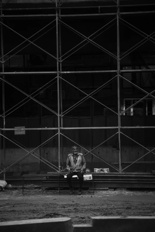 a man is sitting on top of train tracks