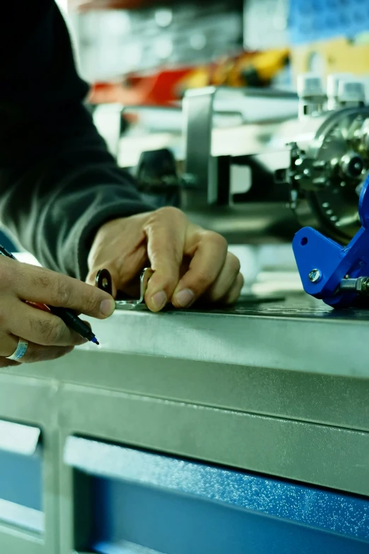 a man working on a metal structure on a machine