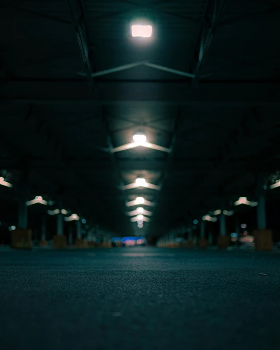 an empty parking garage with lights on at night