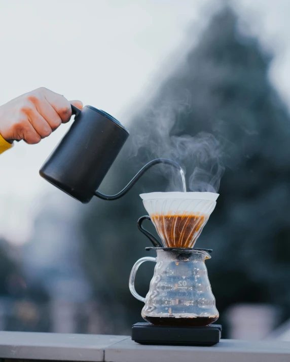 the coffee press has steam rising from it