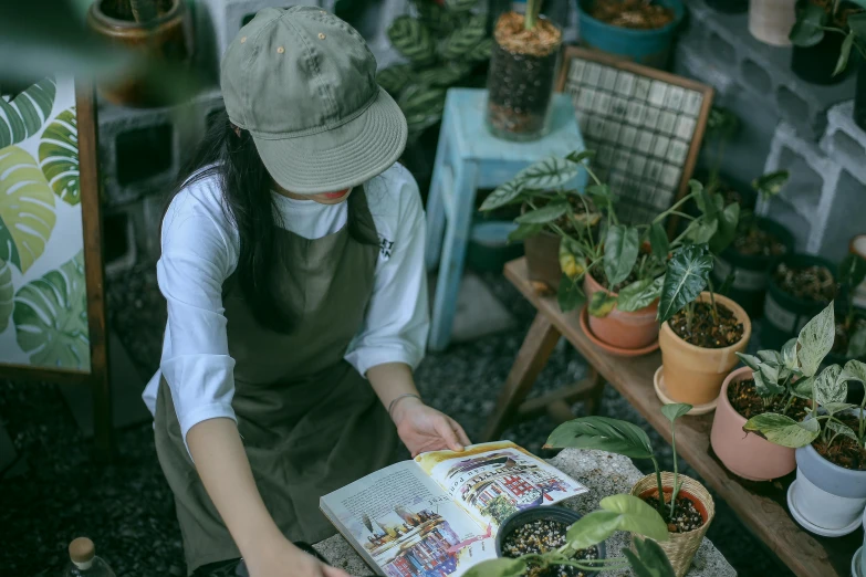 a girl is sitting down reading a book