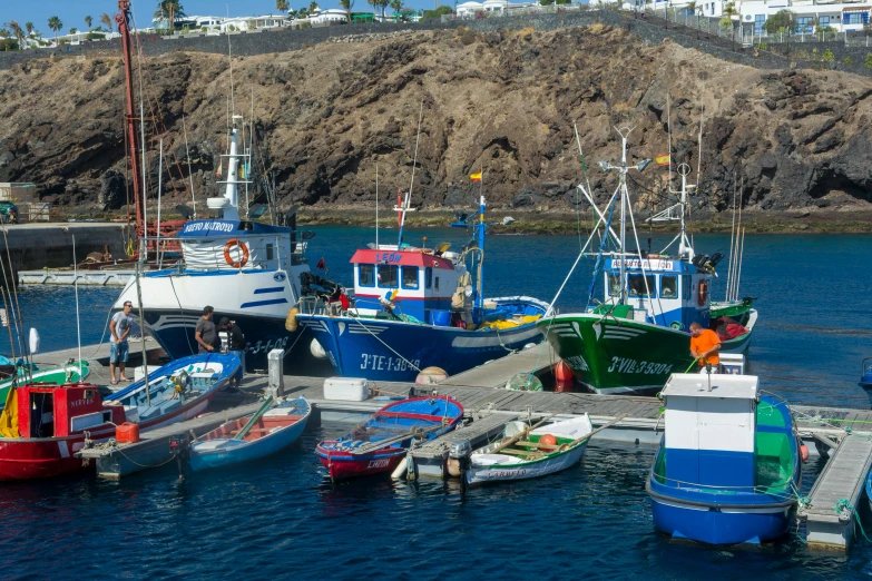 small and large boats moored at a dock