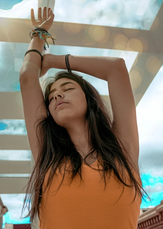 a woman wearing a hat in front of a white ceiling