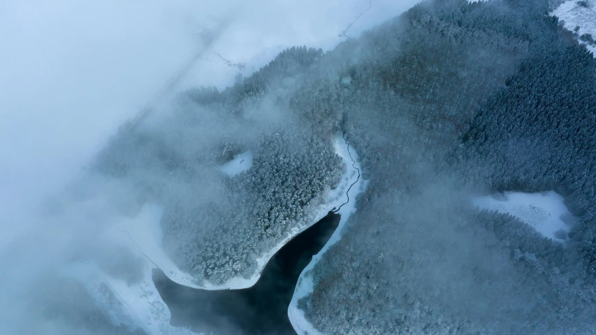 an ice covered hillside with the top snowing