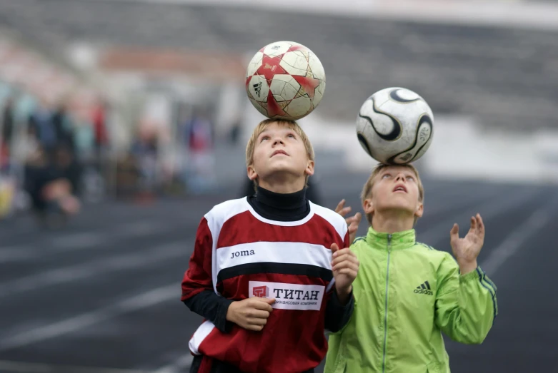 a couple of boys that are playing with a soccer ball