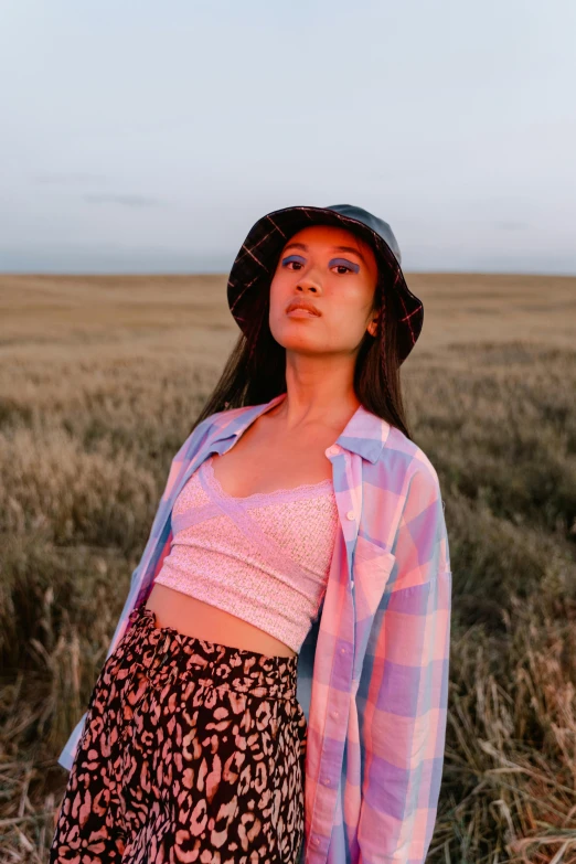 a woman standing on a field looking away