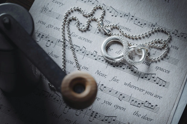 a necklace with musical notes, and a pair of scissors