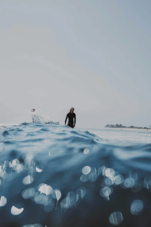 the man is coming out of the water while surfing