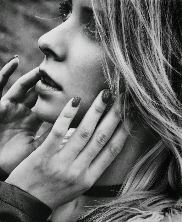 a woman is smoking a cigarette and holding her hand