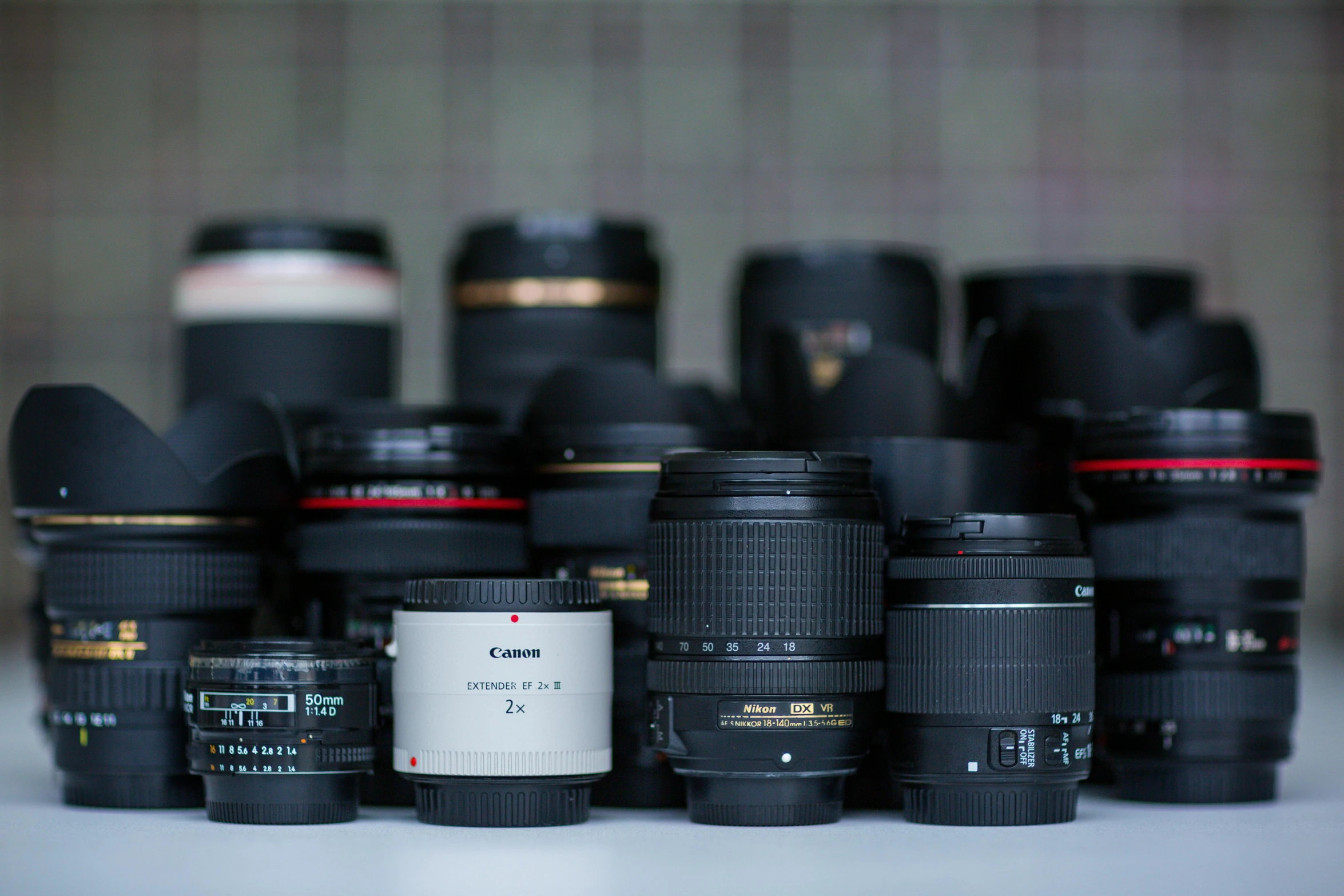 a table topped with lots of different types of camera lenses