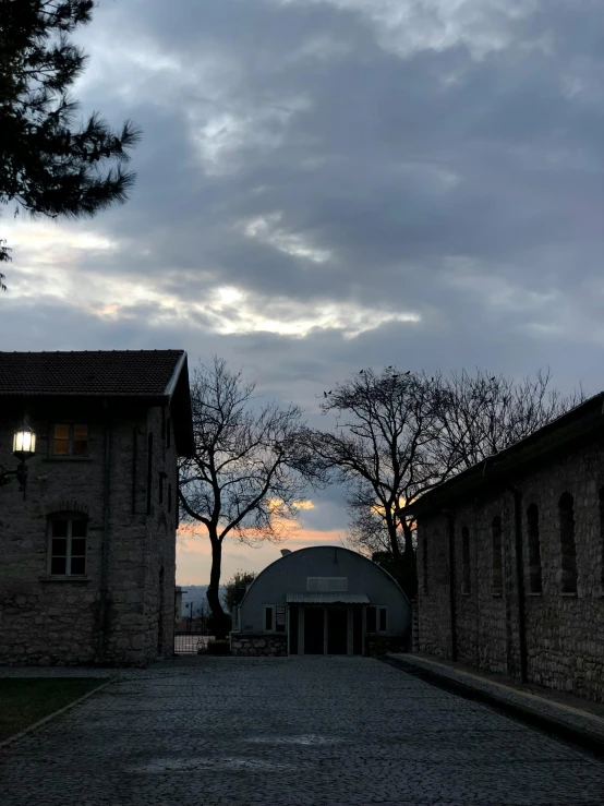 a dark stone driveway near some building