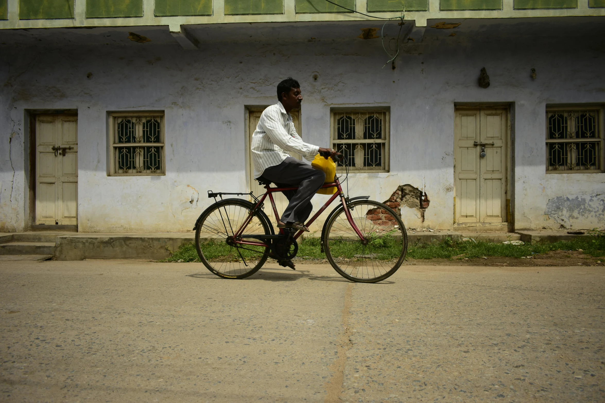 a man is riding a bike down the street