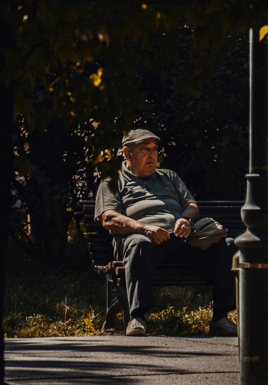 an older man is sitting on a bench looking at his watch