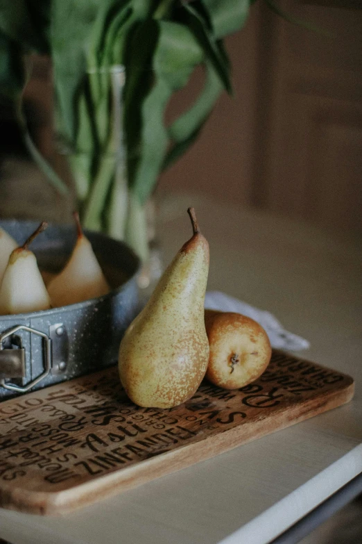 an old, antique measuring tray has fruit in it