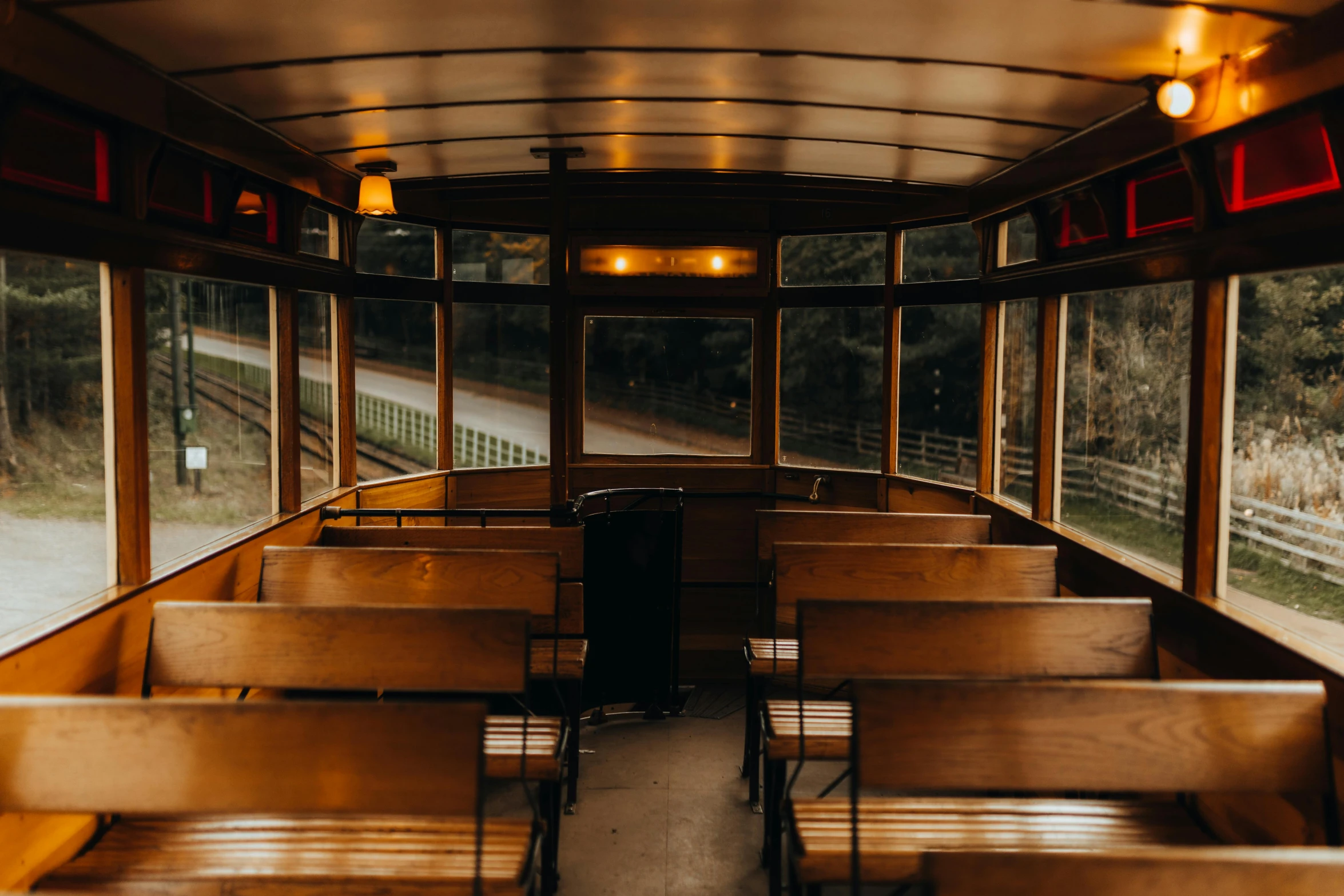 the inside of a bus with many tables and benches