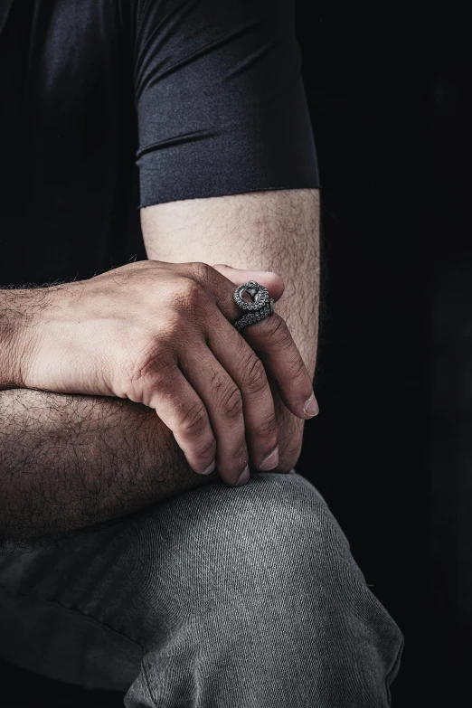 a man in a black shirt with his arm around the mans shoulder