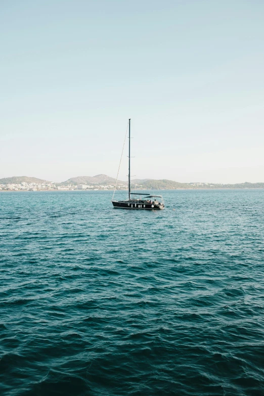 a boat floats in the sea near a city