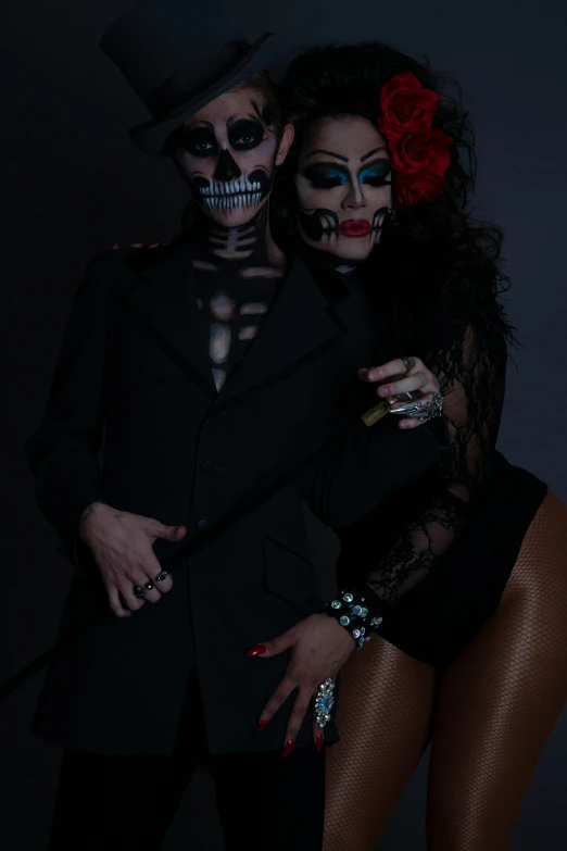 two people dressed in costumes and make up as skeleton makeup