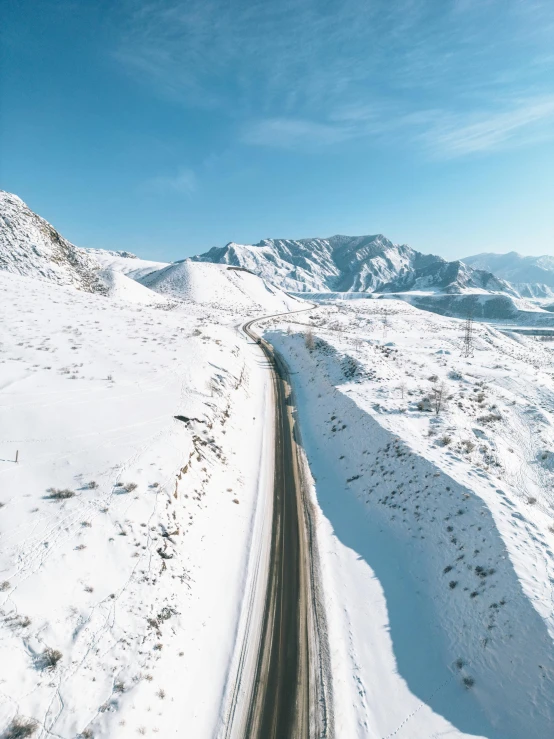 a view of the snowy road from the top