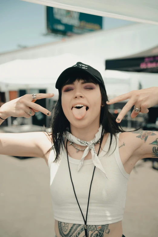 a woman making a v sign and sticking out her hand