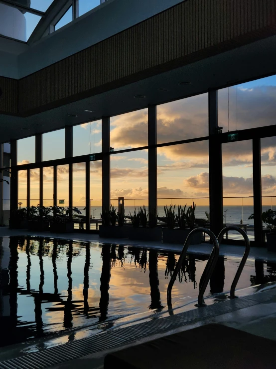 this is an indoor swimming pool with a view of the water