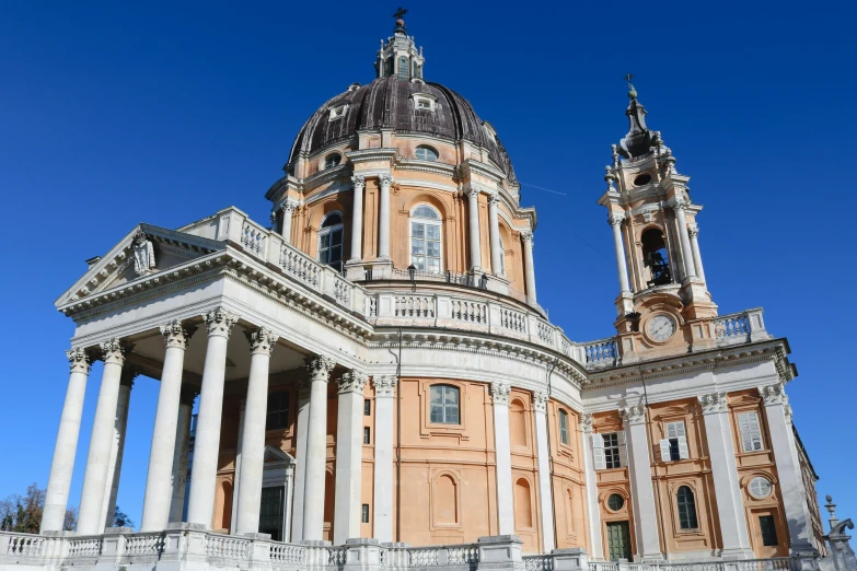 this beautiful church has a tall spire and a clock