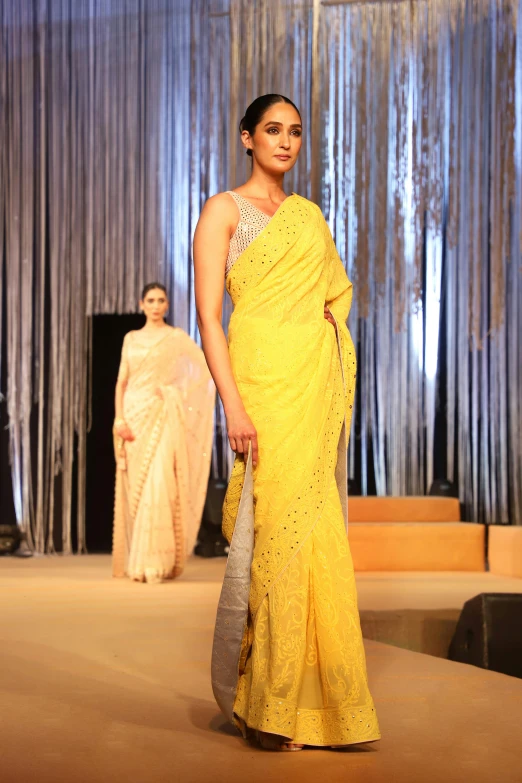 a beautiful young woman in a yellow saree