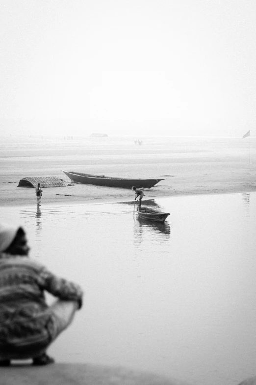 men are fishing in small boats on the water