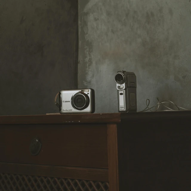 a couple of cameras sitting on top of a desk