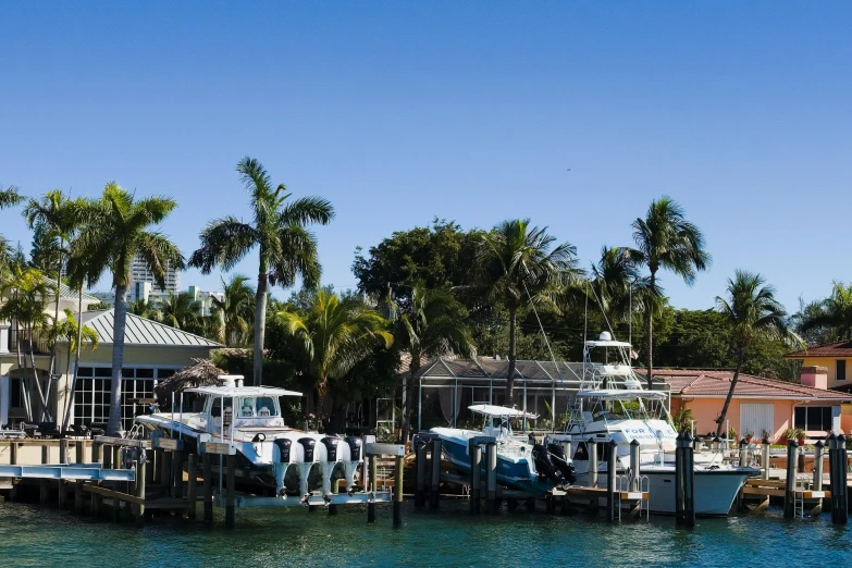 boats and buildings sitting in the marina near a river