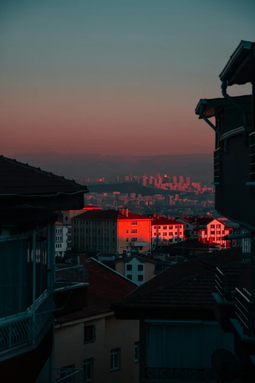 a view of a sunset with buildings and a city in the background