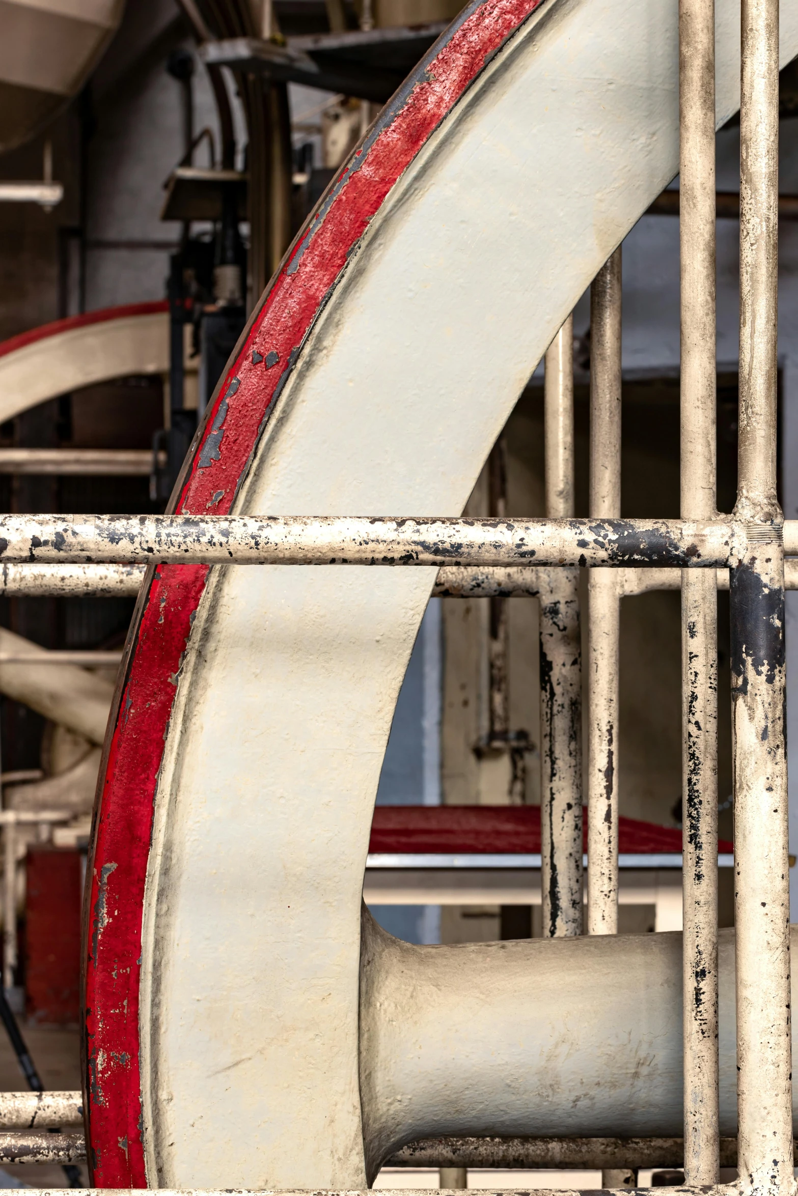 a red and white decorative object near a pipe