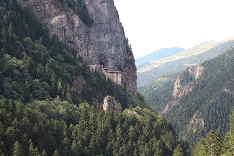 a small building on the top of a steep mountain