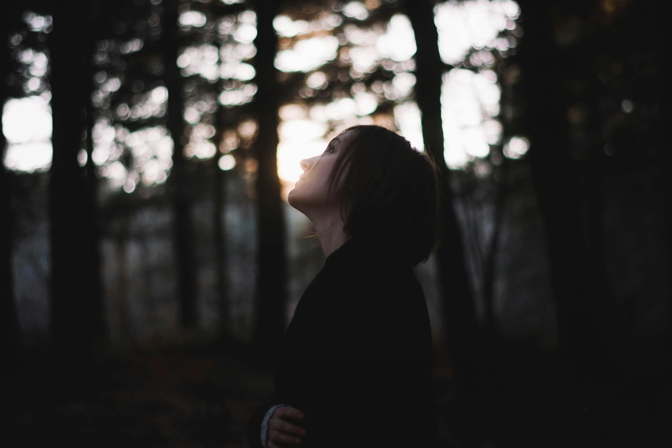 a person standing in front of some trees