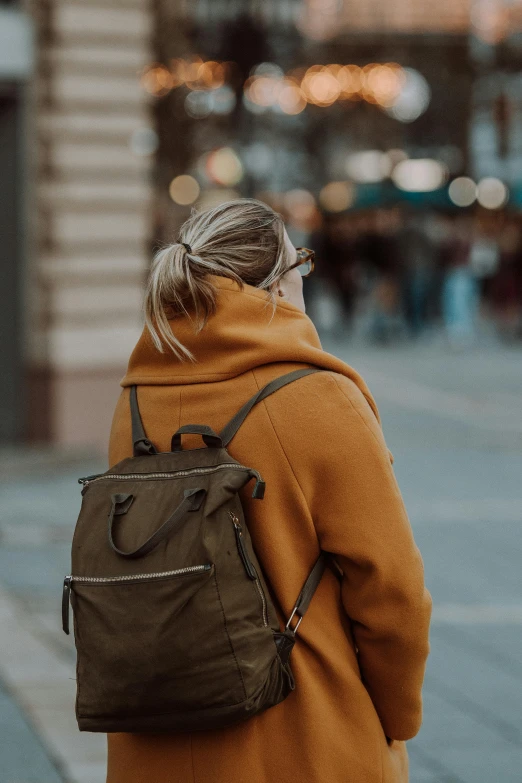 a woman with blonde hair walks down the street