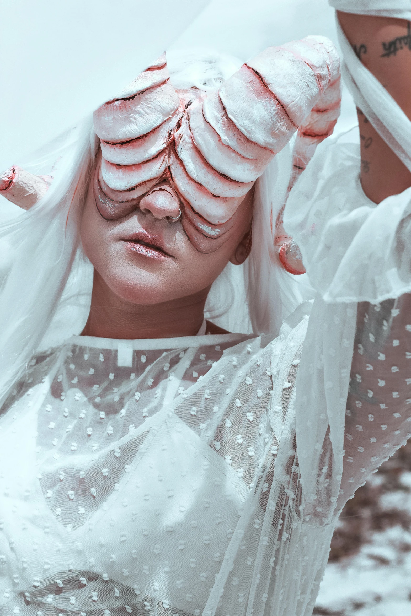 a woman is wearing all white in her headgear