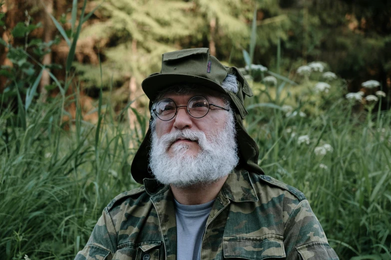 a bearded man wearing a hat and glasses