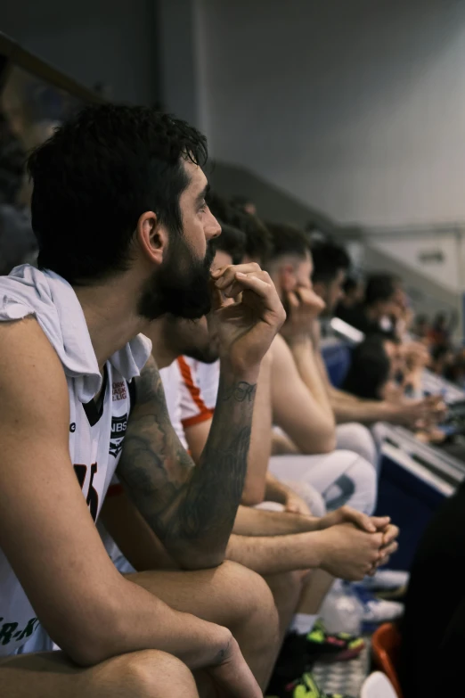 a man with a goatee on his head sits in the front row