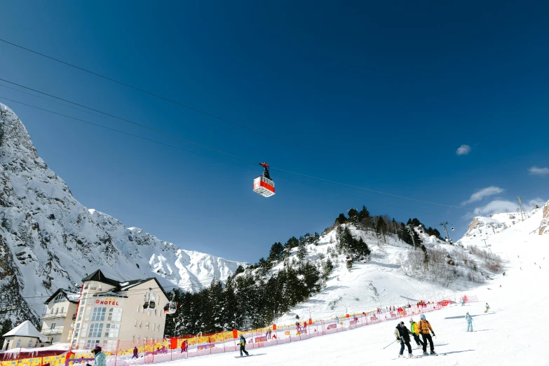 a group of people riding skis down the side of a snow covered mountain